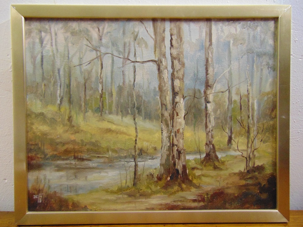 A framed oil on board of trees by a river, monogrammed bottom right, 34 x 44.5cm