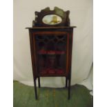 An Edwardian rectangular mahogany inlaid bow front glazed display cabinet surmounted by an oval