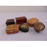 Six papier mache covered boxes of various shape, colours and form