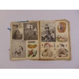 A Victorian scrap book album with cut out images mounted on cloth pages