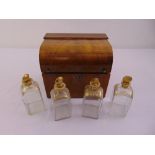 A Victorian rectangular mahogany case, the hinged arched cover revealing four gilded cut glass