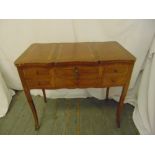 A rectangular kingswood dressing table, the central section lifts to reveal a dressing table mirror,