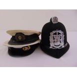 Three hats to include a policemans helmet, a Gieves and Hawkes captains hat and a mid 20th century