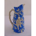 A Staffordshire Victorian blue ground jug with applied figures and naturalistic forms, mark to the