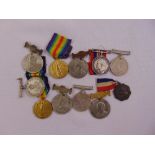 A quantity of WWI and WWII medals some with ribbons