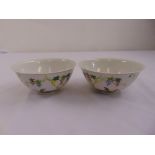 Two Chinese rice bowls decorated with flowers, berries and leaves