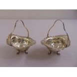 A pair of silver bonbon dishes with swing handles on paw feet, Birmingham 1906
