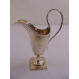 A silver cream jug, vase form with reeded loop handle on square base, Birmingham 1905
