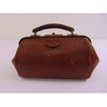 A leather Gladstone bag of customary form