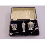 A cased set of silver condiments comprising mustard pot, pepperette, salt and two condiment spoons