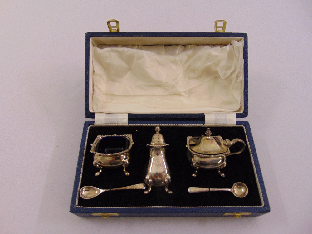 A cased silver three piece condiment set to include two spoons