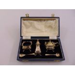A cased silver three piece condiment set to include two spoons