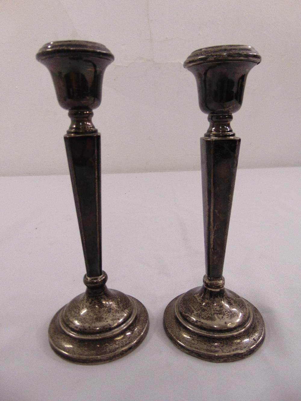 A pair of silver filled table candlesticks, Birmingham 1957