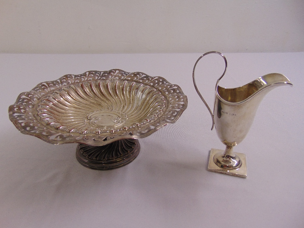 A silver cake stand, circular, scroll pierced and fluted on raised circular base, Birmingham 1906