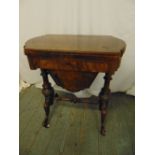 A 19th century walnut and mahogany games and sewing table of shaped rectangular form on four knopped