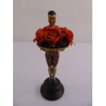 A cast card stand in the form of an oriental figure on raised circular base