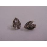 A pair of white metal and diamond earrings