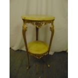An onyx and gilded metal side table, circular with scrolling supports