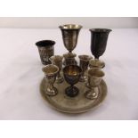 A quantity of white metal Kiddush cups and a circular tray (11)