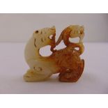 A Chinese mutton fat jade figurine of a dog of foe