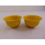 Two Chinese yellow ground rice bowls decorated with dragons and bats