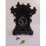 A Black Forest cuckoo clock of customary form, the dial with Roman numerals, to include key,