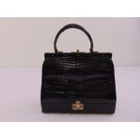 A 1930s black crocodile skin ladies handbag