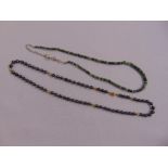 14ct yellow gold and hematite bead necklace and a green stone necklace