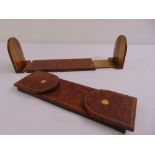 A pair of walnut book slides with hinged arched ends