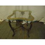 A rectangular gilt metal side table with glass top on four scroll legs