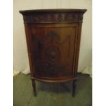 A shaped rectangular mahogany music cabinet, bow front with anthemion border, the hinged door with