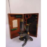 A Swift microscope in fitted mahogany case, to include one additional lens