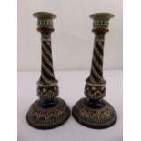 A pair of Doulton Lambethware decorative table candlesticks on raised circular bases with acanthus