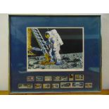 A framed and glazed polychromatic poster and stamp display of the lunar landing dated 1969, 45.5 x