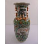 A Cantonese vase decorated with mythological figures, flowers, scrolls and leaves