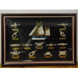 A framed and glazed nautical knots with labels and a miniature sailing boat display, 46 x 66.5cm