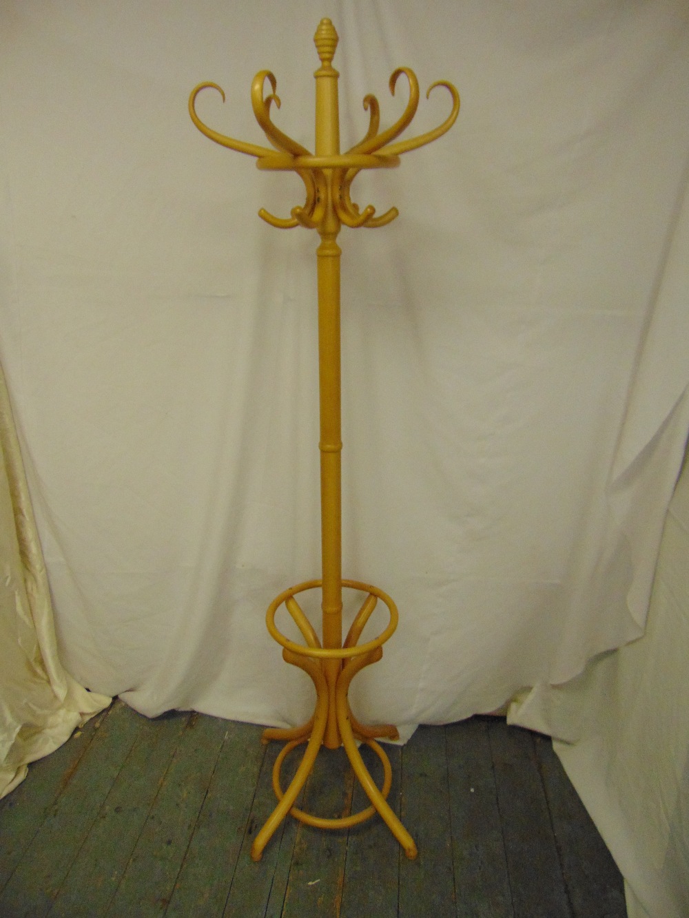 A bentwood hat and coat stand of customary form on four outswept legs