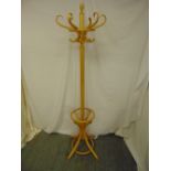 A bentwood hat and coat stand of customary form on four outswept legs