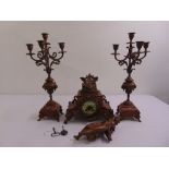 A 19th century French gilded metal and marble clock set flanked by two five light matching