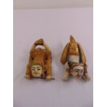 A pair of painted Tibetan carved wooden figurines