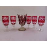 A Bohemian overlaid glass with ruby roundels on raised circular foot and five Venetian cranberry