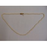 A cultured pearl single strand necklace with articulated gold clasp