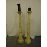 A pair of wooden alter candlesticks, tapering cylindrical on octagonal bases