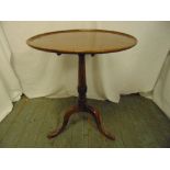 A Victorian mahogany circular tilt top occasional table on three outswept legs