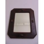 A mahogany framed Arts and Crafts shaped rectangular bevelled edge wall mirror