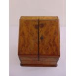A walnut rectangular stationery box, hinged covers, brass estcheon on rectangular base
