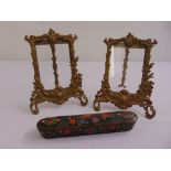 A pair of gilded metal photograph frames and a Persian papier mache pencil case