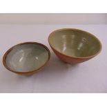 Two Leach family Cornish ceramic bowls with glazed interiors, marks to the bases