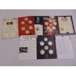 A quantity of commemorative coins in folders to include Winston Churchill, St George and the