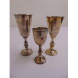 Three silver Kiddush cups of varying size